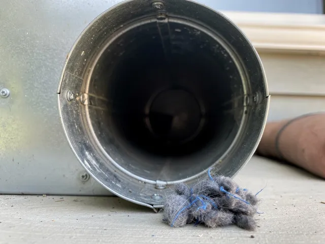 Norwell Dryer Vent Cleaning technician using specialized equipment to clear severe dryer vent blockage in Norwell